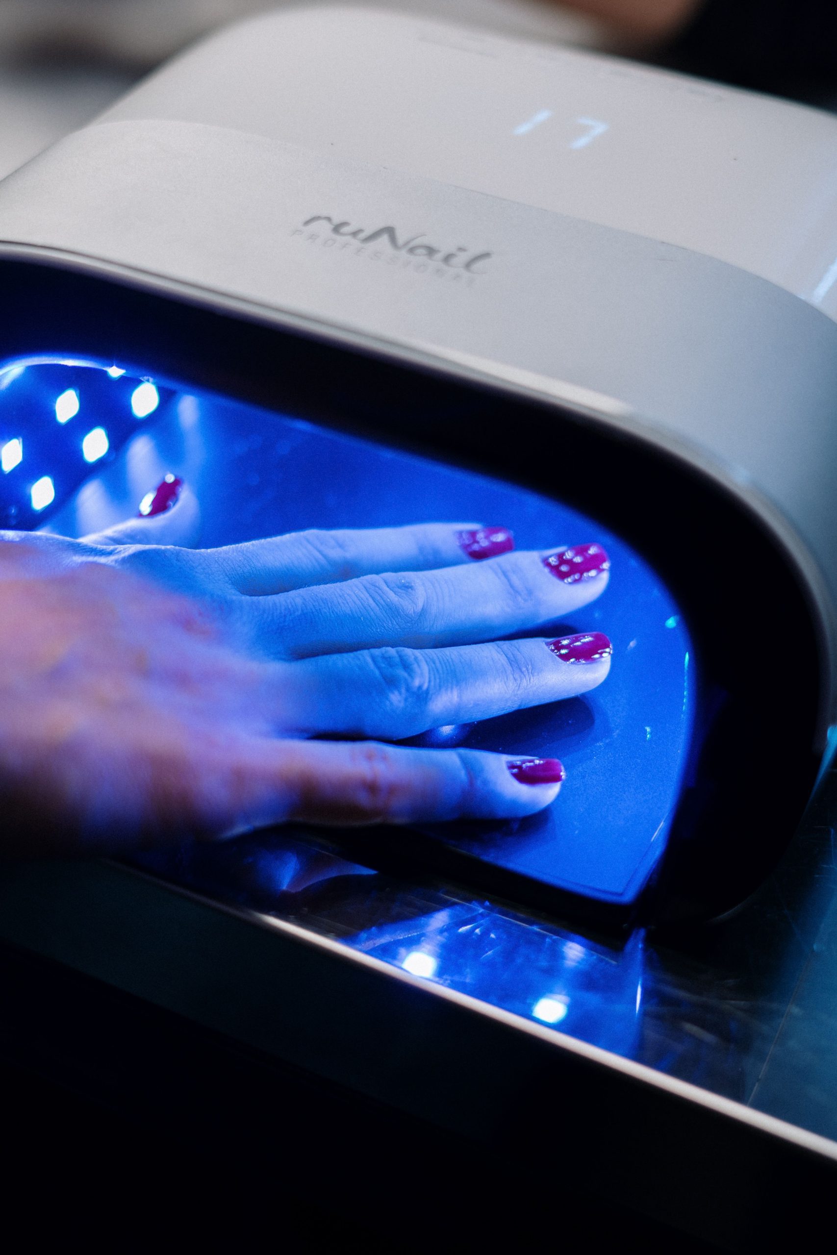 gel nails curing under UV light at nail salon in Dubai